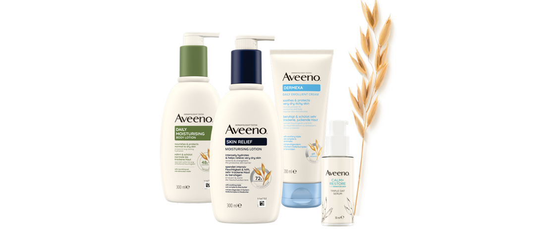 Aveeno zwei Spenderflaschen, eine Tube, ein kleiner Pumpspender von Aveeno sowie eine Hafer-Ähre