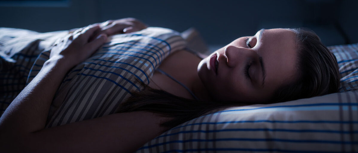 Traum deuten: Bedeutung für die Psyche Schlafende Frau bei Nacht im Bett