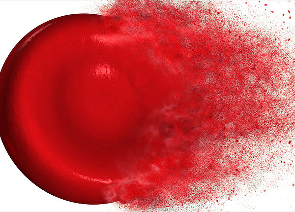 Ein rotes Blutkörperchen löst sich in Staub auf.