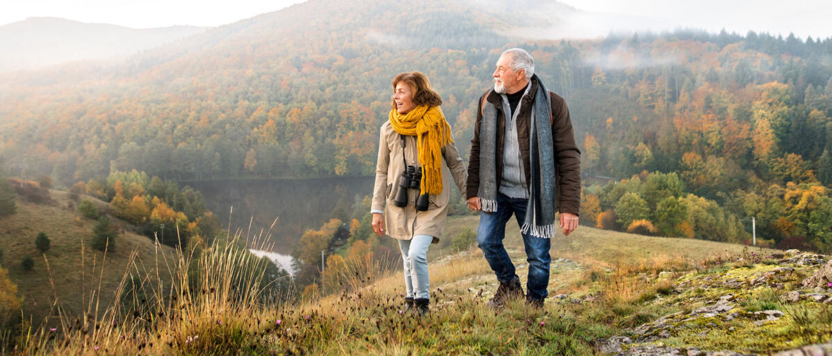 Älteres Paar geht zusammen durch die Natur spazieren
