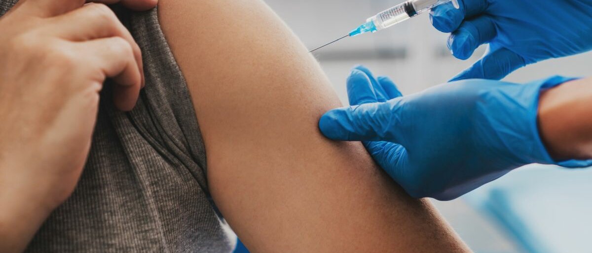 Impfung Eine Person, die gerade geimpft wird.