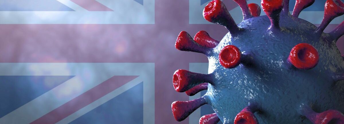 Das Coronavirus vor der Flagge Großbritanniens.
