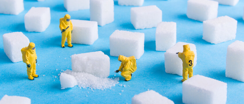 Kleine gelbe Männchen untersuchen Würfelzucker