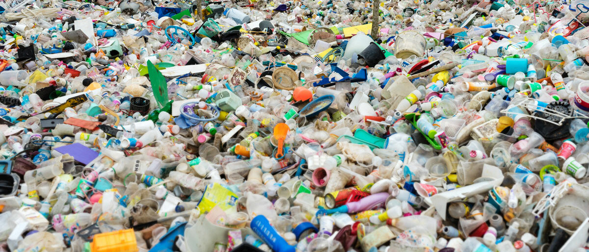 Ein riesiger Haufen Plastik im Wald.