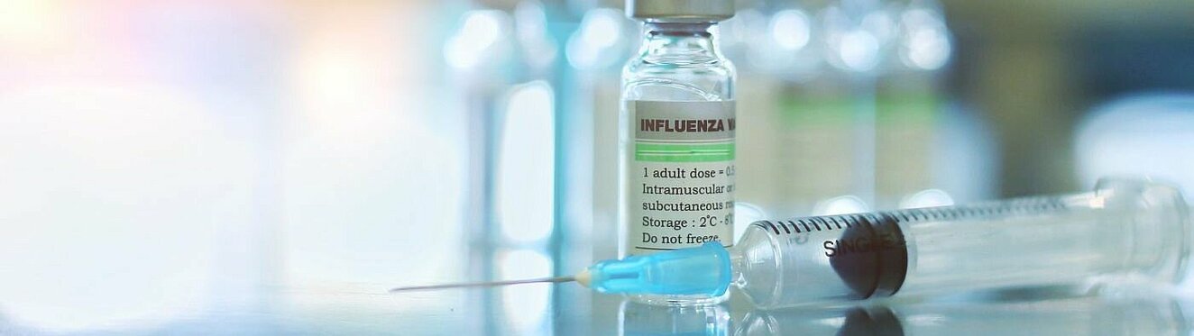 Influenza-Impfstoff und eine Spritze