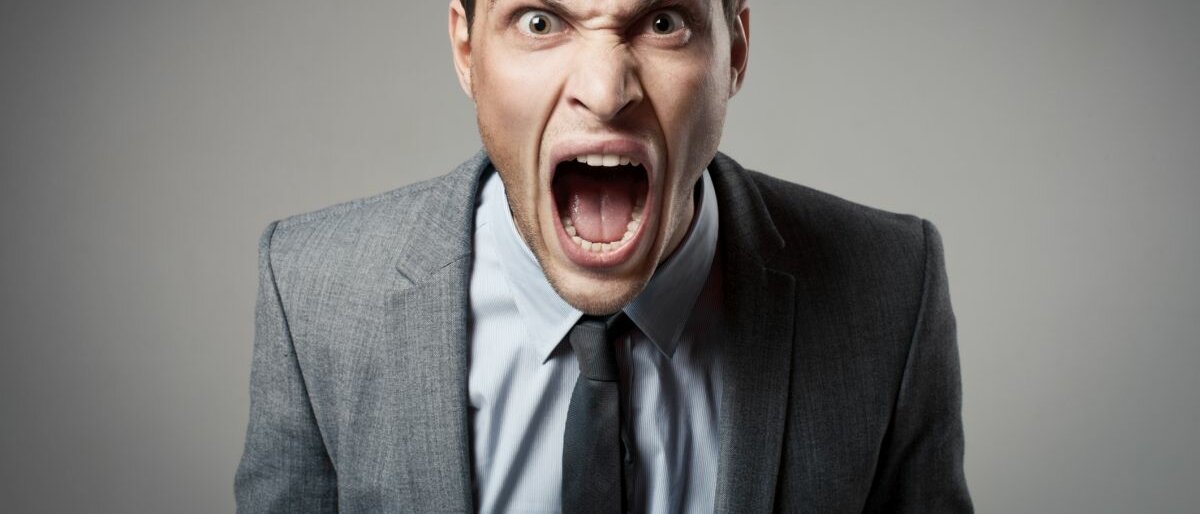 Aggressivität Ein Mann schaut schreiend in die Kamera.